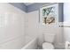 This bathroom features a classic design with a white tub, toilet, and window at 288 Fink Nw Ave, Concord, NC 28025