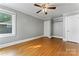 Sunny bedroom with hardwood floors, ceiling fan, and closet space at 288 Fink Nw Ave, Concord, NC 28025