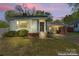 Home featuring a covered carport, decorative iron porch accents, and landscaped yard at 288 Fink Nw Ave, Concord, NC 28025