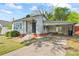 Single-story home with a brick foundation, covered parking, and small front yard at 288 Fink Nw Ave, Concord, NC 28025