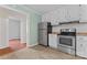 Galley kitchen featuring white cabinets and stainless steel appliances at 288 Fink Nw Ave, Concord, NC 28025