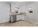 Cozy kitchen area featuring white cabinets, stainless steel dishwasher, and a window view at 288 Fink Nw Ave, Concord, NC 28025