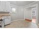 Bright kitchen space with ample white cabinetry and tiled floors at 288 Fink Nw Ave, Concord, NC 28025