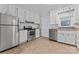 Efficient kitchen featuring white cabinets, stainless steel appliances, and tiled flooring at 288 Fink Nw Ave, Concord, NC 28025