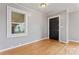 Hardwood floors and a black door provide a clean look to an unfurnished room at 288 Fink Nw Ave, Concord, NC 28025