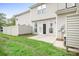 Backyard featuring small patio with grassy area and white privacy fence at 3906 Thomas Ridge Dr, Charlotte, NC 28269