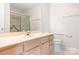 Well-lit bathroom with a shower-tub combo, a spacious vanity, and neutral-toned walls and flooring at 3906 Thomas Ridge Dr, Charlotte, NC 28269