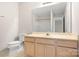 Well-lit bathroom showing a vanity, toilet, and large mirror over vanity at 3906 Thomas Ridge Dr, Charlotte, NC 28269