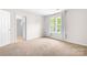 Bedroom featuring carpet flooring, ample natural light, and a neutral color scheme at 3906 Thomas Ridge Dr, Charlotte, NC 28269
