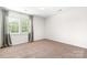 Inviting bedroom with soft carpeting, curtains and a window letting in natural light at 3906 Thomas Ridge Dr, Charlotte, NC 28269