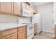 Bright kitchen with white appliances, light wood cabinets, and ample counter space at 3906 Thomas Ridge Dr, Charlotte, NC 28269