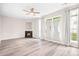 Bright living room with fireplace, modern flooring, and large windows showcasing natural light at 3906 Thomas Ridge Dr, Charlotte, NC 28269
