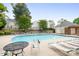 Community pool featuring lounge chairs, nearby clubhouse and trees at 3906 Thomas Ridge Dr, Charlotte, NC 28269