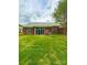 Spacious backyard with lush green grass, a brick home, and sliding glass doors at 4223 Willow View Ct, Matthews, NC 28105