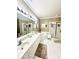 Bright bathroom boasts double sinks, spacious tub, and a separate glass-enclosed shower at 4223 Willow View Ct, Matthews, NC 28105