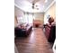 Inviting bedroom with ceiling fan, hardwood floors, and a desk next to a big window at 4223 Willow View Ct, Matthews, NC 28105