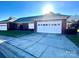 Charming brick home with an attached garage, a well-manicured lawn, and a sunny, blue sky at 4223 Willow View Ct, Matthews, NC 28105