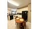 Open kitchen featuring a breakfast bar, black appliances, and a tile backsplash at 4223 Willow View Ct, Matthews, NC 28105