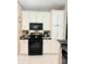 Bright kitchen with white cabinets and black appliances at 4223 Willow View Ct, Matthews, NC 28105