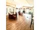 Open-concept living space with laminate flooring, a fireplace and adjoining dining area at 4223 Willow View Ct, Matthews, NC 28105