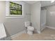 Bathroom featuring tiled floors, toilet, and shower at 510 S Carolina Ave, Spencer, NC 28159