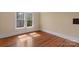 Bright bedroom featuring hardwood floors and a large window allowing for ample natural light at 510 S Carolina Ave, Spencer, NC 28159