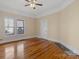 Bedroom featuring hardwood floors, a ceiling fan, and windows at 510 S Carolina Ave, Spencer, NC 28159