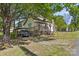 View of the rear exterior of the house with a deck and car port at 510 S Carolina Ave, Spencer, NC 28159