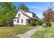 Exterior front of home features mature landscaping and covered porch at 510 S Carolina Ave, Spencer, NC 28159