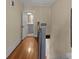 Hallway featuring hardwood floors and trim leading to bathroom at 510 S Carolina Ave, Spencer, NC 28159