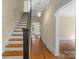 Hallway with hardwood floors, a staircase, and an open doorway to another room at 510 S Carolina Ave, Spencer, NC 28159