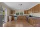 Traditional kitchen with stainless steel appliances, wood cabinets, and ample counter space at 510 S Carolina Ave, Spencer, NC 28159