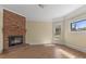 The living room boasts a brick fireplace and sunlight streaming through the window at 510 S Carolina Ave, Spencer, NC 28159