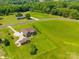 Large lot with a brick home, a detached garage, and lush green surroundings at 514 Clover Leaf Rd, Marshville, NC 28103