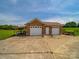 Three-car brick garage with ample parking space and a well-maintained exterior at 514 Clover Leaf Rd, Marshville, NC 28103