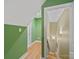 Hallway with green accent wall and hardwood flooring at 514 Clover Leaf Rd, Marshville, NC 28103