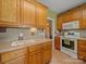 Kitchen with wood cabinets, tile countertops, and stainless-steel oven and microwave at 514 Clover Leaf Rd, Marshville, NC 28103