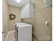 Laundry room with white cabinets and modern washer and dryer units at 514 Clover Leaf Rd, Marshville, NC 28103