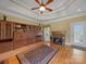 Spacious living room boasts a cozy fireplace, custom built-ins, and abundant natural light at 514 Clover Leaf Rd, Marshville, NC 28103