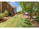 Expansive backyard with lush lawn, landscaping, hardscaping, water feature, storage shed, and brick house at 5283 Fieldstone Dr, Concord, NC 28025