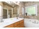 Elegant bathroom features double sinks, soaking tub, and shower with decorative tile at 5283 Fieldstone Dr, Concord, NC 28025