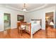 Bedroom featuring hardwood floors, a wood-frame bed, and an ensuite bathroom entrance at 5283 Fieldstone Dr, Concord, NC 28025