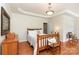 Inviting bedroom with a wooden bed frame, hardwood floors, and tray ceiling at 5283 Fieldstone Dr, Concord, NC 28025