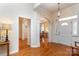 Bright foyer with hardwood floors, featuring an arched entrance and elegant lighting at 5283 Fieldstone Dr, Concord, NC 28025
