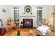 Cozy living room with fireplace, black marble hearth, and light-filled windows at 5283 Fieldstone Dr, Concord, NC 28025