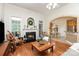 Bright living room with fireplace, hardwood floors, and archway to kitchen at 5283 Fieldstone Dr, Concord, NC 28025