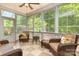 Relaxing sunroom with wicker furniture and views of the lush backyard at 5283 Fieldstone Dr, Concord, NC 28025