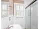 Bathroom with white tile, glass shower door, and modern fixtures at 539 Marsh Rd, Charlotte, NC 28209