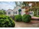 Charming home featuring a well-manicured front yard, decorative bushes, and a classic brick pathway leading to the front door at 539 Marsh Rd, Charlotte, NC 28209