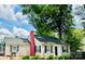Charming single-Gathering home featuring a pink brick chimney, lush landscaping, and inviting curb appeal at 539 Marsh Rd, Charlotte, NC 28209